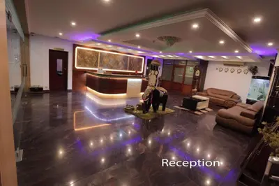 a living room with a couch and an elephant statue in it at Hotel Chithrapuri in Parli