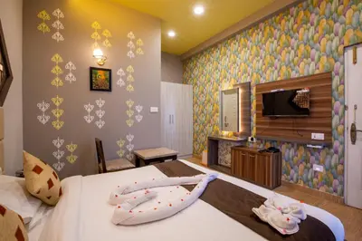 a hotel room with two beds with towels on them at Paradise Point Ooty in Ooty