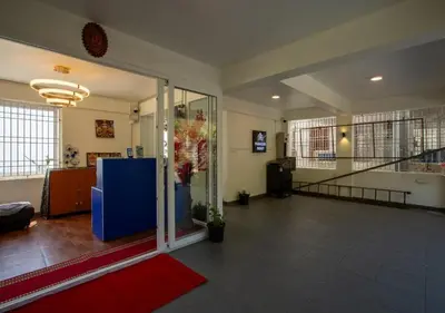 an empty lobby with a staircase in a building at Paradise Point Ooty in Ooty