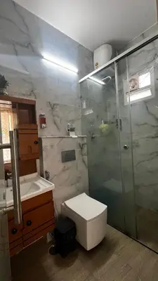 a bathroom with a shower and a toilet and a sink at Lotus Exotica Homestay in Suntikoppa