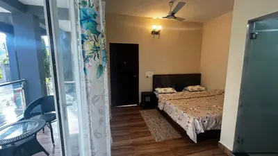 a small bedroom with a bed and a window at Lotus Exotica Homestay in Suntikoppa