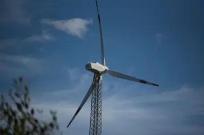 a windmill is shown against a blue sky at wild grove resorts in Varagampadi