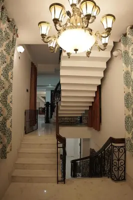 a chandelier and stairs in a house at Palamattam Villa Homestay,Angamaly, Kochi, Airport in Cochin