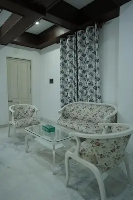 a living room with two chairs and a glass table at Palamattam Villa Homestay,Angamaly, Kochi, Airport in Cochin