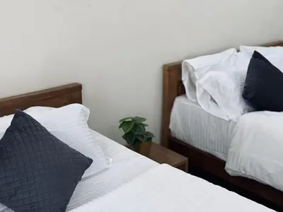 two beds sitting next to each other in a bedroom at Thamarassery INN luxury and budget Rooms in Thamarassery