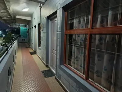 a hallway of a kitchen with a window at River View Homestsy in Vālpārai