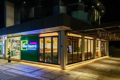 a store front at night with its doors open at Nexstay Time Square in Kozhikode