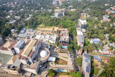 an aerial view of a city with buildings at Nexstay Time Square in Kozhikode