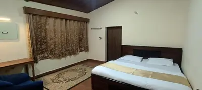 a bedroom with a large bed and a window at Jungle view in Coonoor