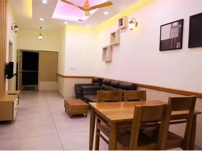 a living room with a couch and a table at Aqualuxe Premium Suites in Vythiri