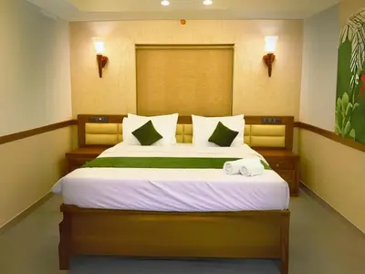a bedroom with a bed with two towels on it at Aqualuxe Premium Suites in Vythiri