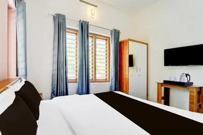 a bedroom with a large bed and a television at Super Collection O Westhill Near Govt Engg College in Calicut