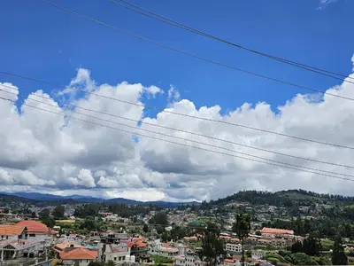 a view of a city under a cloudy sky at Mellowlux Ooty in Ooty