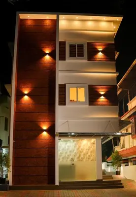 a building with lights on the side of it at ALPHA inn in Alwaye