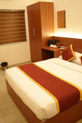 a bedroom with a large bed in a room at ALPHA inn in Alwaye