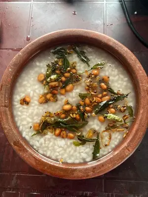 a bowl of soup with beans and greens in it at Captain's Castle in Pallipuram