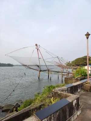a large boat sitting on a dock in the water at Captain's Castle in Pallipuram