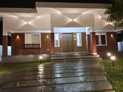 a house with two lights in front of it at Captain's Castle in Pallipuram