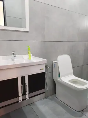 a bathroom with a toilet and a sink at Captain's Castle in Pallipuram