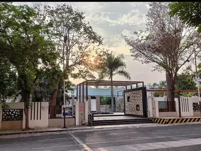 a gate to a bus stop on the side of a street at Regi's Adobe - Entire Place -Service Apartment for Rent in Coimbatore