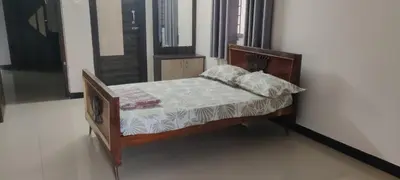 a small bed with a wooden frame in a room at Regi's Adobe - Entire Place -Service Apartment for Rent in Coimbatore