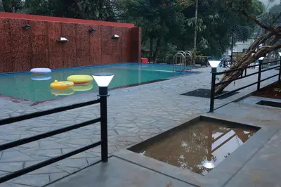 a swimming pool with a playground and a swimming pool at Blizzard Pool Villa in Padinjarathara