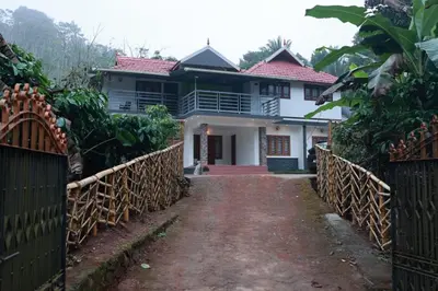 a house with a gate in front of it at Blizzard Pool Villa in Padinjarathara