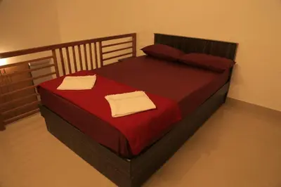 a bedroom with a bed with two towels on it at Blizzard Pool Villa in Padinjarathara