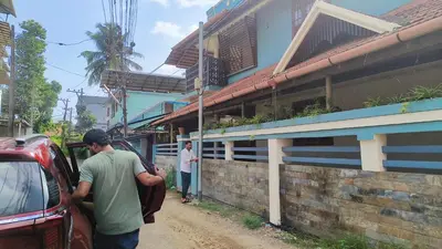 a man getting into a car on a dirt road at Ashirvad Homes in Mannārakkāt
