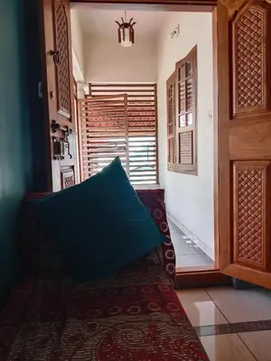 a living room with a couch and a window at Ashirvad Homes in Mannārakkāt