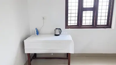 a white table in a room with a window at CozyHaven in Quilāndi