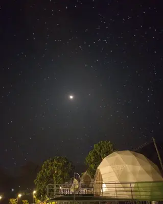 a starry night with a moon and a domed tent at Wildglamps Athirappilly in Athirappilly