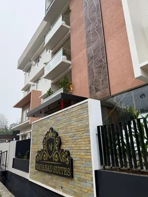 a building with a sign that reads vaughald suites at AJ Wayanad Suites in Kalpetta