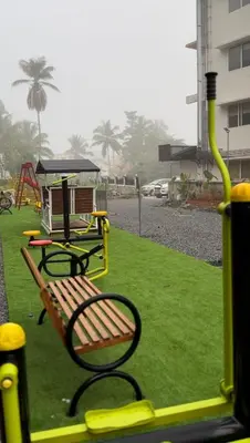 a park with a bench and a playground at AJ Wayanad Suites in Kalpetta
