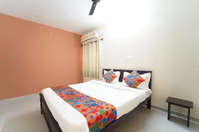 a bedroom with a large bed in a room at Subam Residency in Singānallūr