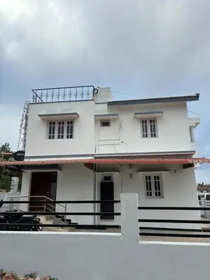 a white house with a fence in front of it at Crown Crest in Ooty