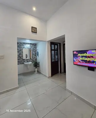 a hallway of a hospital with a tv on a wall at Thiruthi Homestay in Vallikunnu