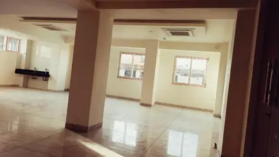 an empty room with two windows and a pillar at Hotel Vintage Classic in Coimbatore