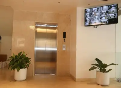 a elevator in a building with two potted plants at Hotel Vintage Classic in Coimbatore