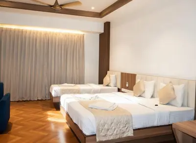 a hotel room with two beds in a room at Hotel Vintage Classic in Coimbatore