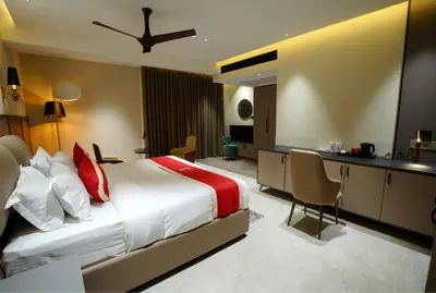 a hotel room with a large bed and a desk at Doro Royal Suite in Mannārakkāt