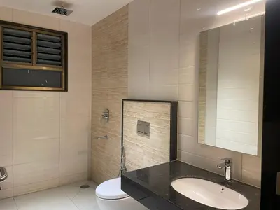 a bathroom with a sink and a toilet at SV Grand in Mettuppālaiyam