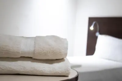 a stack of towels sitting on top of a table at SV Grand in Mettuppālaiyam