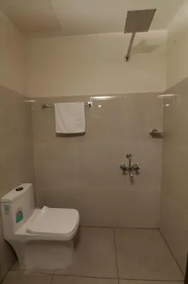 a bathroom with a toilet and a shower at Hotel Eastern in Sultan Bathery