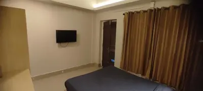 a bedroom with a bed and a television on the wall at Hotel Eastern in Sultan Bathery