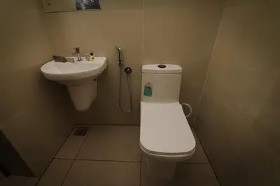 a bathroom with a toilet and a sink at Hotel Eastern in Sultan Bathery