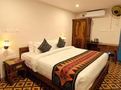 a bedroom with a large bed in a room at Ibex Resorts, Coimbatore Kakarla in Alāndurai