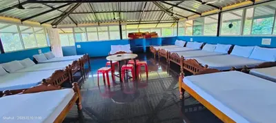 a room with rows of tables and chairs and a table at Mountain View Villas in Madikeri