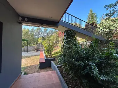 a house with a staircase and a stair case at Mountain View Villas in Madikeri