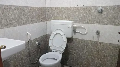 a bathroom with a toilet and a sink at Aswathy Bhavan Near Star auditorium vadakkenchery in Palakkad